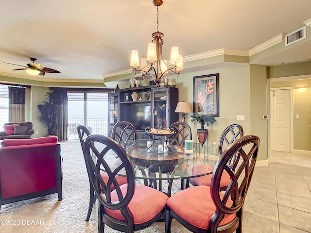 dining area with ceiling fan with notable chandelier, light tile patterned flooring, and crown molding