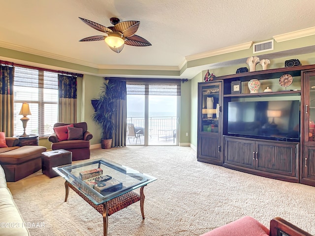 2403 S Atlantic Ave Unit 409, Daytona Beach Shores, FL 32118 - living area featuring carpet flooring, ornamental molding, ceiling fan, baseboards, and a textured ceiling