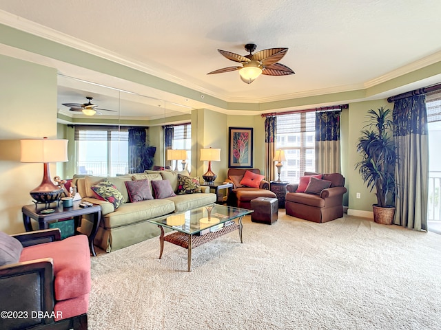 living room with carpet floors, ceiling fan, and crown molding