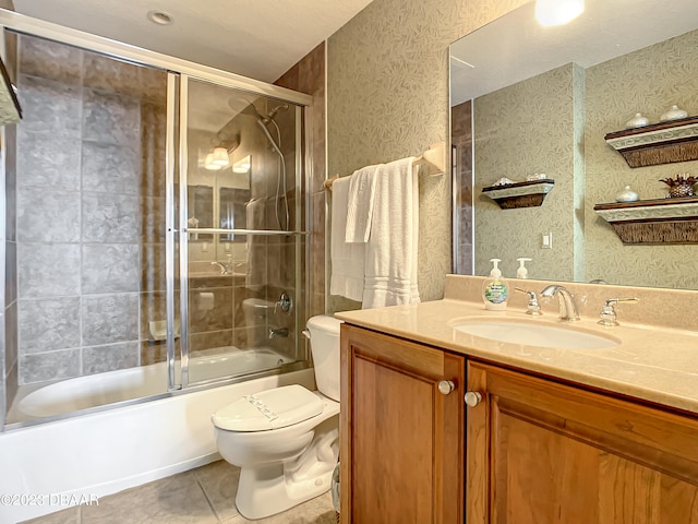 full bathroom with tile patterned flooring, shower / bath combination with glass door, toilet, and vanity