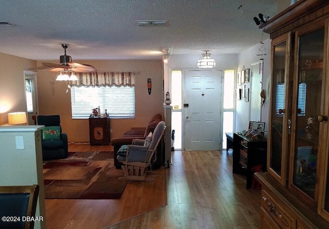 interior space with hardwood / wood-style floors, a textured ceiling, and ceiling fan