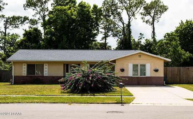 ranch-style home with a front lawn