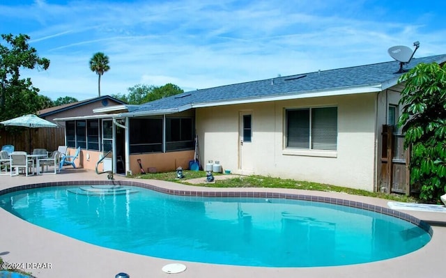 view of pool featuring a patio and a sunroom