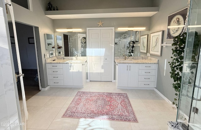 bathroom featuring vanity, tile patterned floors, and walk in shower