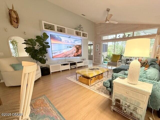 living room featuring wood-type flooring, vaulted ceiling, and ceiling fan