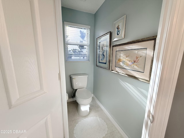 bathroom with tile patterned flooring and toilet