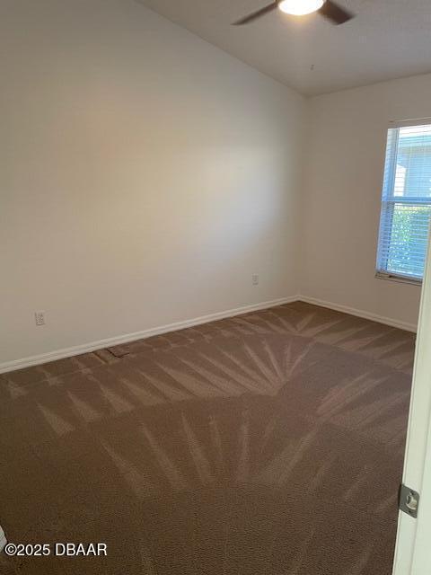 carpeted empty room featuring ceiling fan