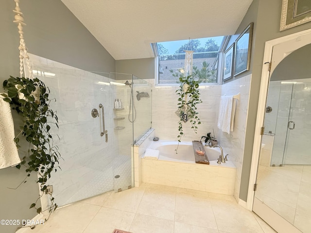 bathroom featuring separate shower and tub, tile patterned floors, and a textured ceiling