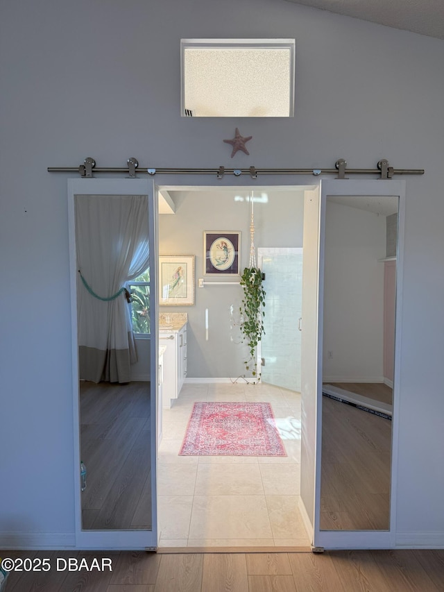 interior space with tile patterned flooring and lofted ceiling