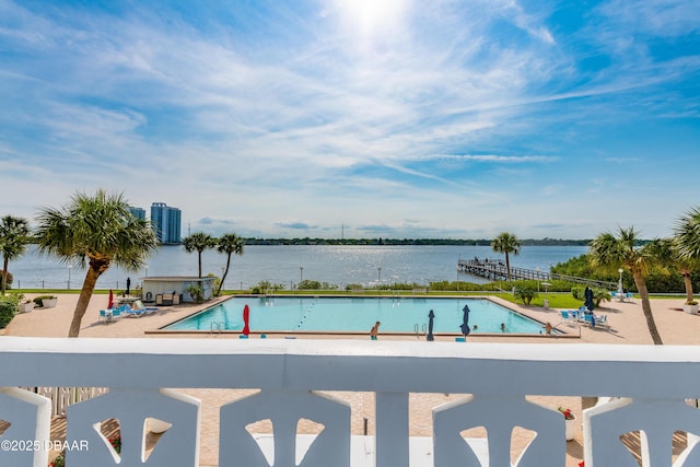 pool with a water view and a patio area