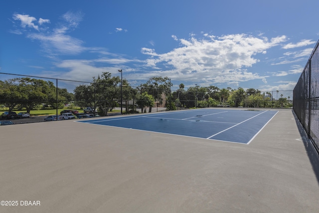 view of tennis court with fence