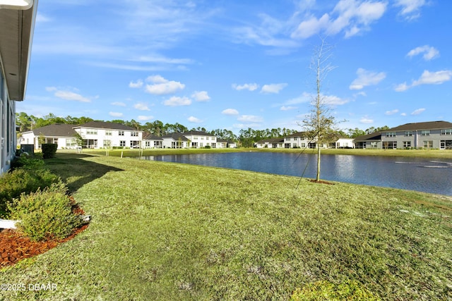 view of yard with a water view and a residential view