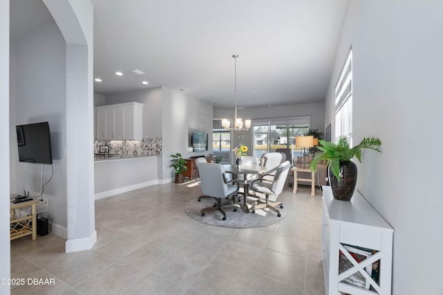 dining space featuring a notable chandelier and light tile patterned flooring