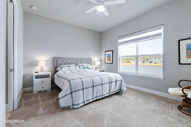 carpeted bedroom with baseboards and a ceiling fan