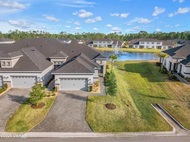 birds eye view of property with a residential view and a water view