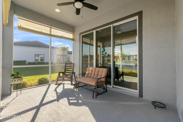 sunroom / solarium featuring ceiling fan