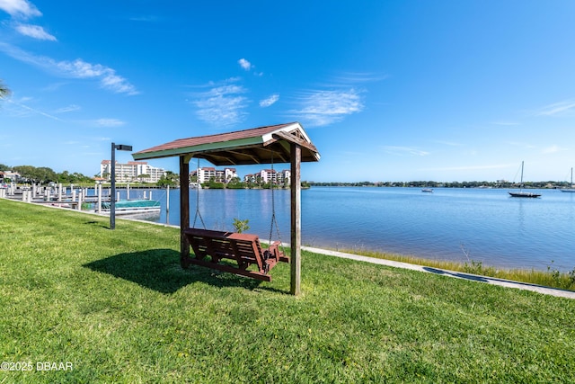 721 S Beach St Unit 205, Daytona Beach, FL 32114 - dock featuring a lawn and a water view