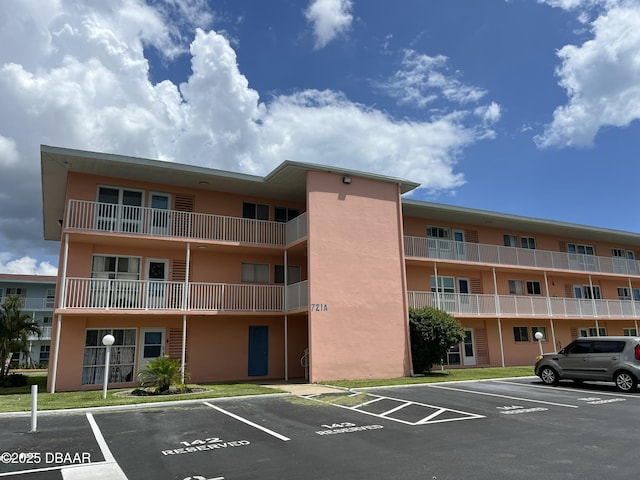 721 S Beach St Unit 205, Daytona Beach, FL 32114 - view of apartment building / complex featuring uncovered parking