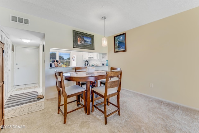 721 S Beach St Unit 205, Daytona Beach, FL 32114 - dining room featuring light carpet and a textured ceiling