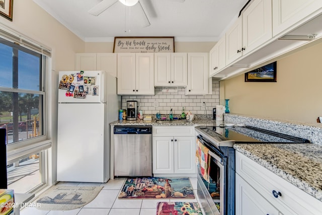 721 S Beach St Unit 205, Daytona Beach, FL 32114 - kitchen featuring stainless steel appliances, white cabinets, backsplash, a ceiling fan, and crown molding