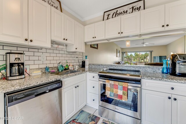 721 S Beach St Unit 205, Daytona Beach, FL 32114 - kitchen featuring stainless steel appliances, white cabinets, ceiling fan, and tasteful backsplash
