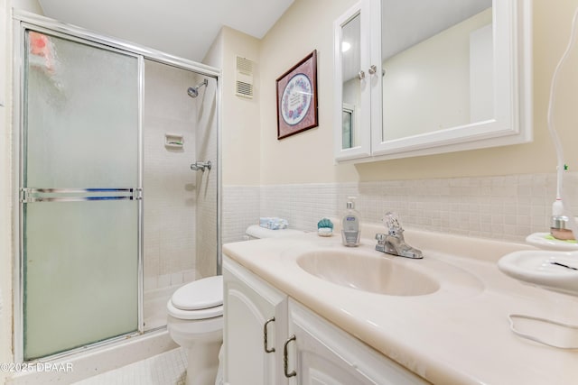 721 S Beach St Unit 205, Daytona Beach, FL 32114 - bathroom with vanity, a stall shower, and tile walls