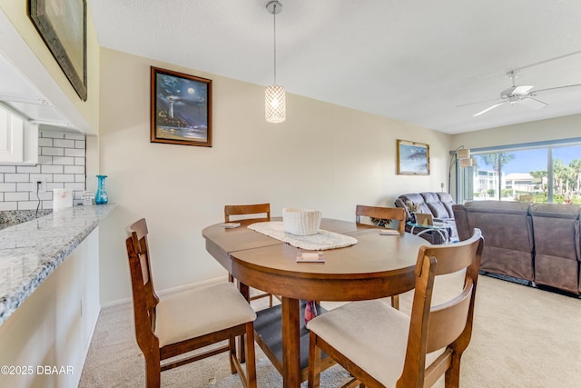 721 S Beach St Unit 205, Daytona Beach, FL 32114 - dining room with light colored carpet and a ceiling fan