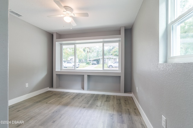 unfurnished room with ceiling fan and light hardwood / wood-style flooring