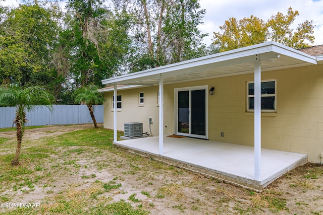 rear view of property with central AC and a patio area