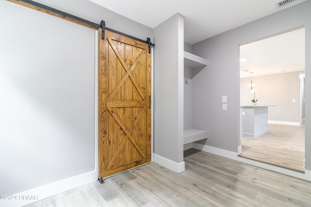 mudroom featuring light hardwood / wood-style floors and a barn door