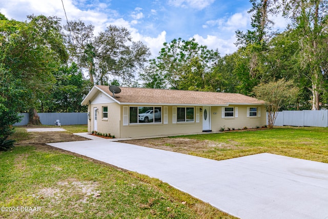 ranch-style house with a patio and a front yard