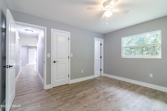 unfurnished bedroom featuring light hardwood / wood-style flooring and ceiling fan