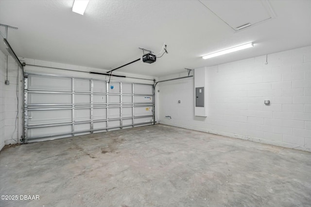 garage with electric panel and a garage door opener