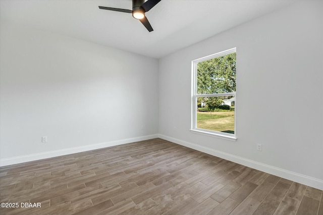 empty room with ceiling fan, a healthy amount of sunlight, and light hardwood / wood-style flooring