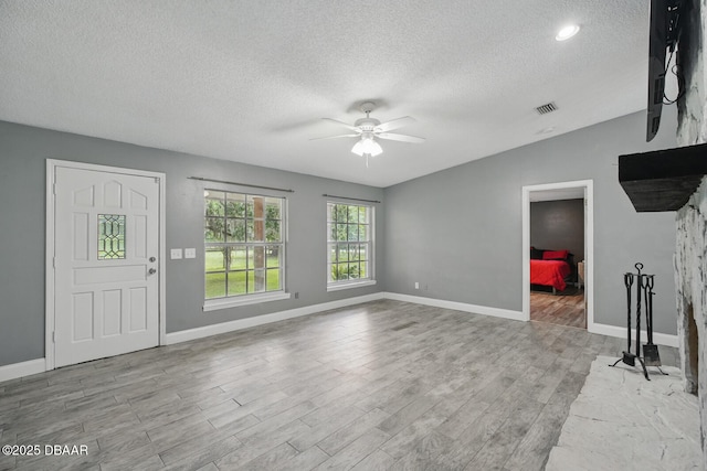 2950 Ragis Rd, Edgewater, FL 32132 - unfurnished living room featuring ceiling fan, a textured ceiling, and wood finished floors