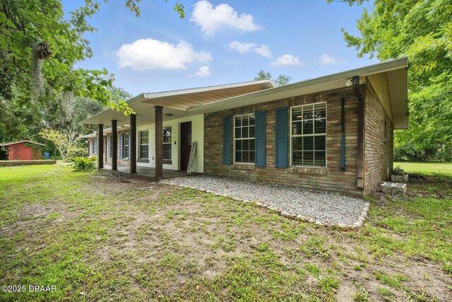 2950 Ragis Rd, Edgewater, FL 32132 - rear view of house featuring a porch