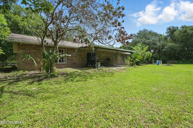 2950 Ragis Rd, Edgewater, FL 32132 - view of grassy yard with a patio