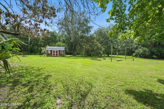2950 Ragis Rd, Edgewater, FL 32132 - view of green lawn featuring a shed and view of scattered trees