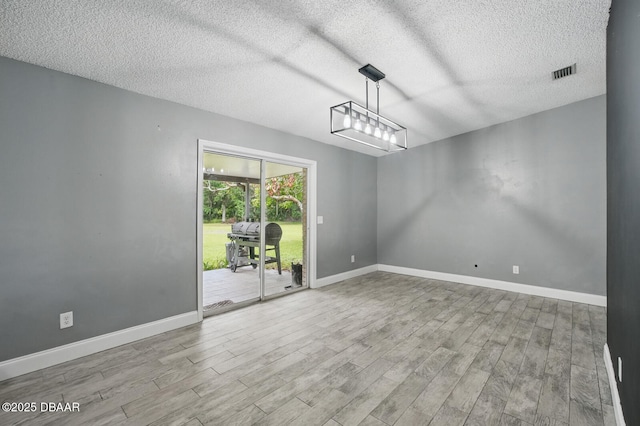 2950 Ragis Rd, Edgewater, FL 32132 - spare room with wood finished floors and a textured ceiling