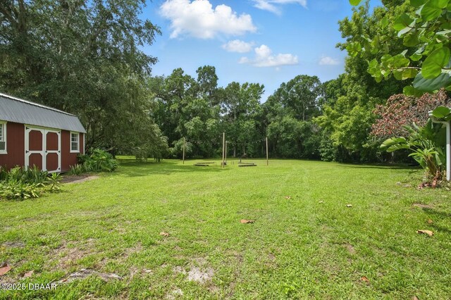 2950 Ragis Rd, Edgewater, FL 32132 - view of green lawn with a storage unit