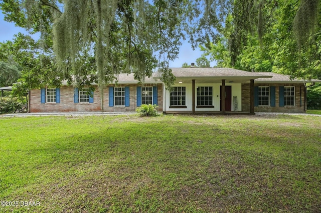 2950 Ragis Rd, Edgewater, FL 32132 - ranch-style home featuring a front lawn