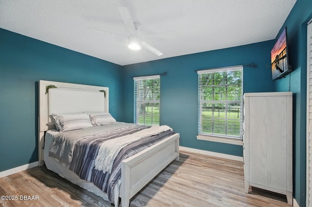 2950 Ragis Rd, Edgewater, FL 32132 - bedroom featuring wood finished floors, a textured ceiling, and a ceiling fan
