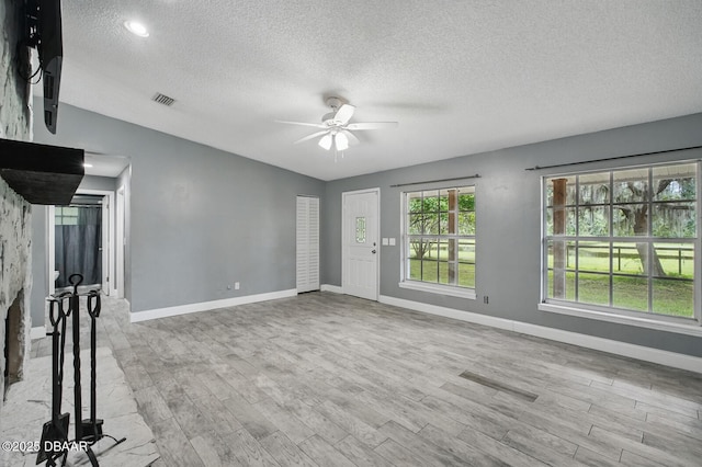 2950 Ragis Rd, Edgewater, FL 32132 - unfurnished living room featuring a textured ceiling, a ceiling fan, wood finished floors, and vaulted ceiling