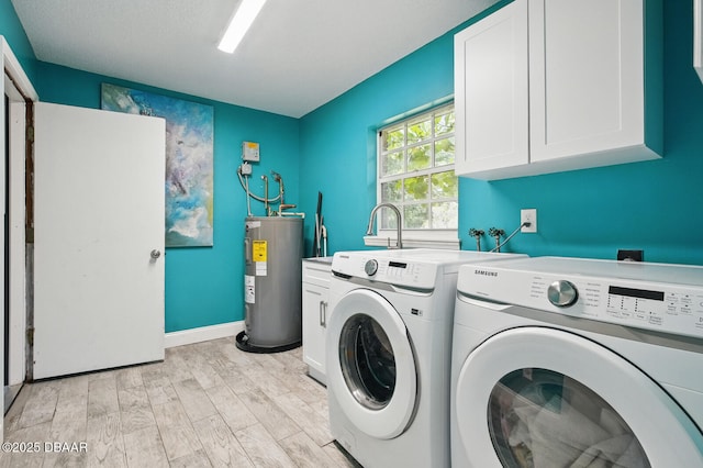 2950 Ragis Rd, Edgewater, FL 32132 - laundry area with water heater, washer and dryer, cabinet space, and light wood finished floors