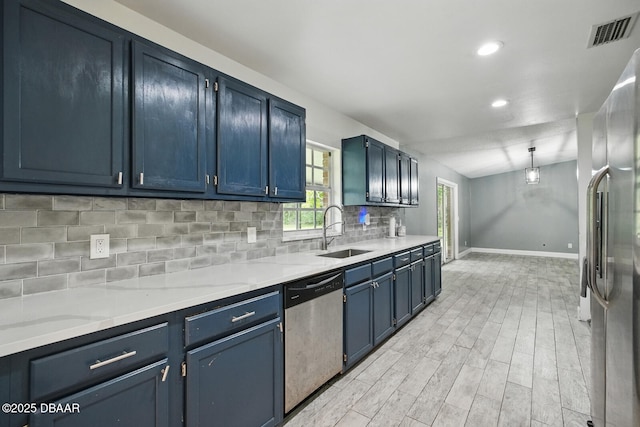 2950 Ragis Rd, Edgewater, FL 32132 - kitchen featuring stainless steel appliances, blue cabinets, decorative backsplash, recessed lighting, and light wood-style flooring