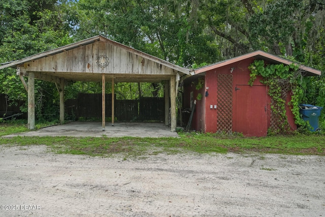 2950 Ragis Rd, Edgewater, FL 32132 - view of vehicle parking with a storage unit and a carport
