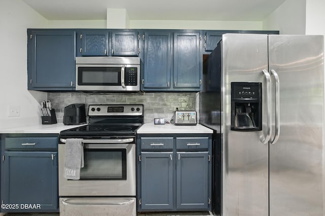2950 Ragis Rd, Edgewater, FL 32132 - kitchen with stainless steel appliances, light countertops, decorative backsplash, and blue cabinets