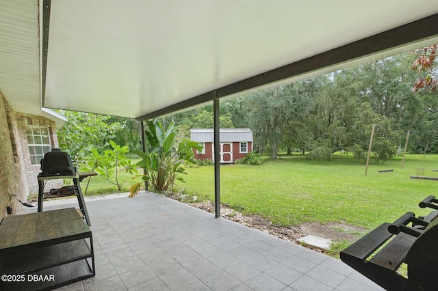 2950 Ragis Rd, Edgewater, FL 32132 - view of patio featuring an outdoor structure, area for grilling, and view of scattered trees