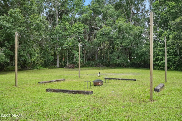 2950 Ragis Rd, Edgewater, FL 32132 - view of grassy yard featuring an outdoor fire pit