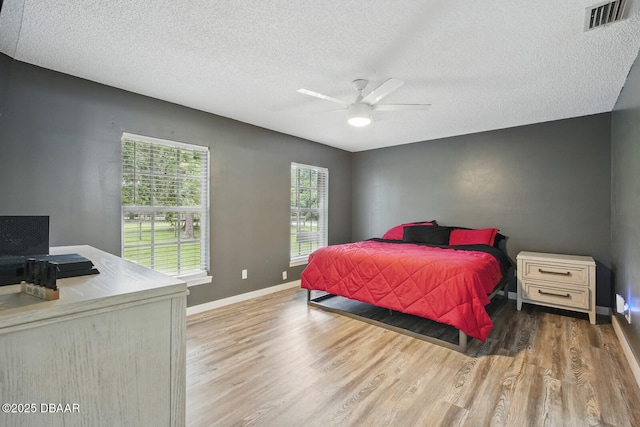 2950 Ragis Rd, Edgewater, FL 32132 - bedroom with wood finished floors, a textured ceiling, and ceiling fan